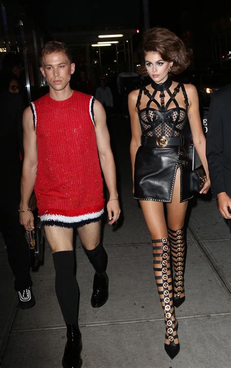 Dua Lipa wears Versace bondage dress on Grammys 2022 red carpet