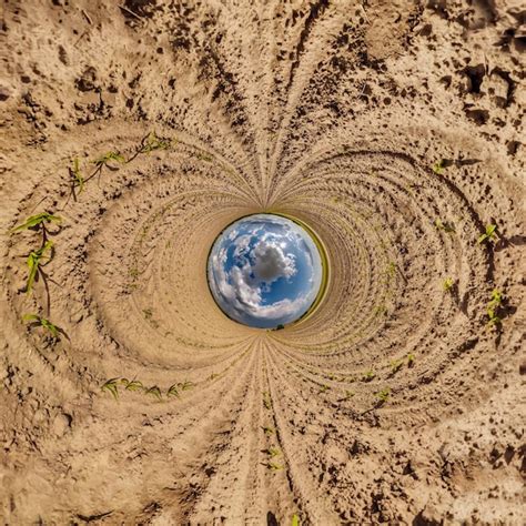 Premium Photo | Blue sphere little planet inside gravel road or field ...