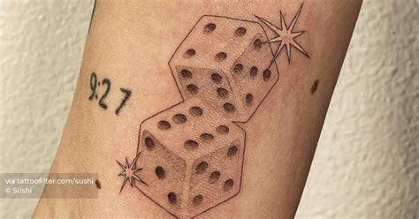 Dice tattoo located on the inner arm.