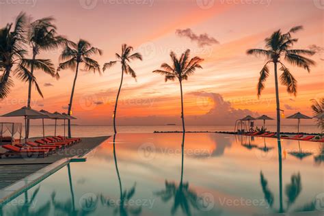 Perfect beach sunset, relaxation pool in a luxurious beachfront hotel