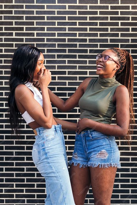 Premium Photo | Couple of young black girls laughing happy in front of