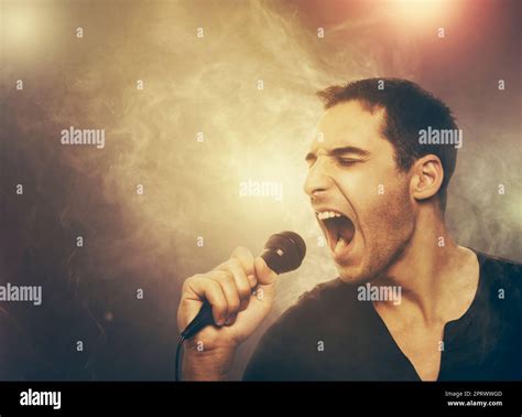 Young man singing rock Stock Photo - Alamy