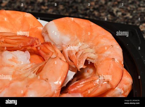 A bundle of uncooked shrimp in a plastic container Stock Photo - Alamy
