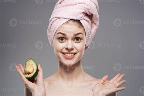 Cheerful woman cropped view of naked shoulders with towel on avocado