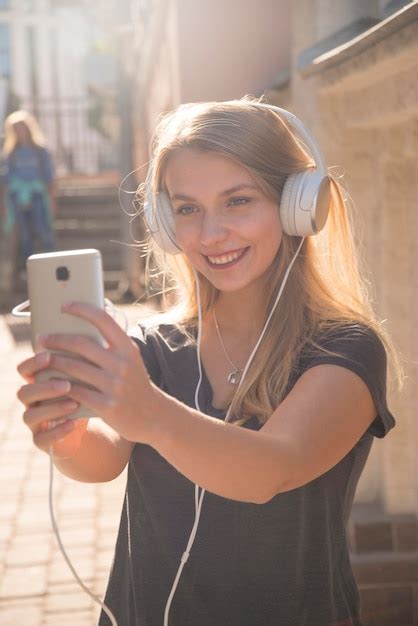 Premium Photo | Girl with headphones listening to music