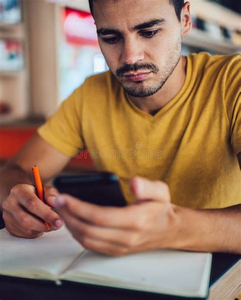 Focused Young Male Student Using Smartphone in Cafe Stock Photo - Image ...