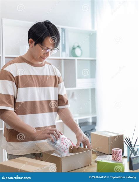 Man is Packing in the Mailbox To Prepare To Deliver it To the Customer