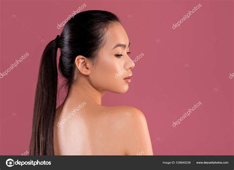 sexy naked chinese woman posing  purple studio background stock