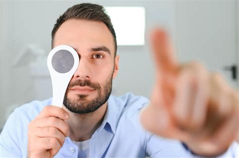 premium photo test  sight man  checking  vision indoors