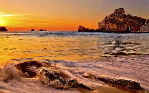 rocky beach  sunset rock form wave beach arch rock sunset