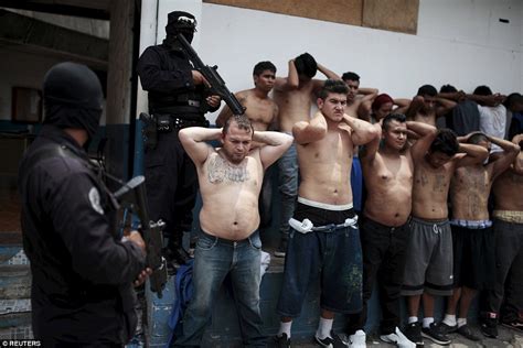 El Salvador's 18th Street gang members pose alongside their guns after ...