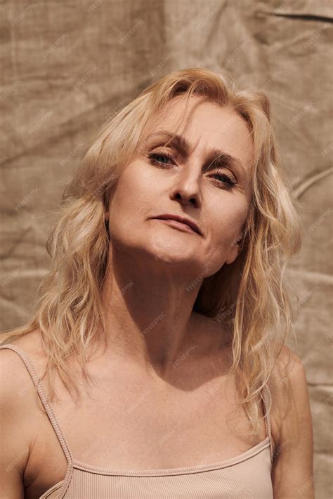 Premium Photo | Beautiful blond middle aged woman strong face looking