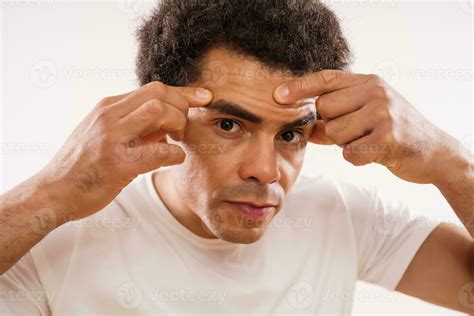 Afro man popping facial pimples 23256572 Stock Photo at Vecteezy