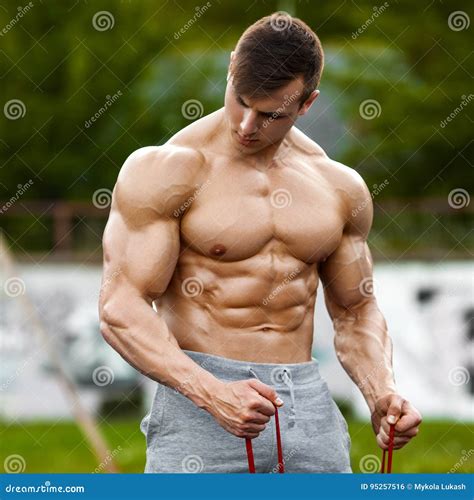 Muscular Man Working Out Outdoor, Doing Exercise. Strong Male Naked