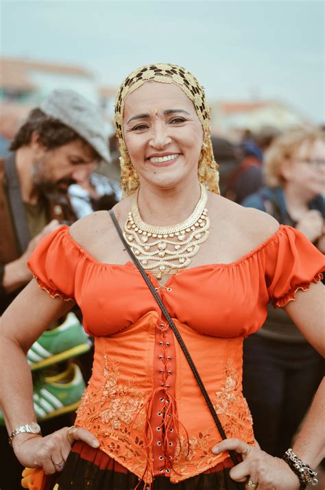 Smiling woman in red dress wearing white crown photo – Free People