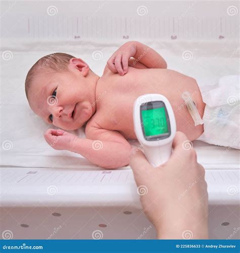 A Mother Measures the Body Temperature of a Newborn Baby with an