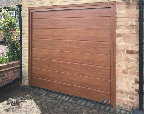 Hormann lpu42 m ribbed sectional garage door finished in golden oak
