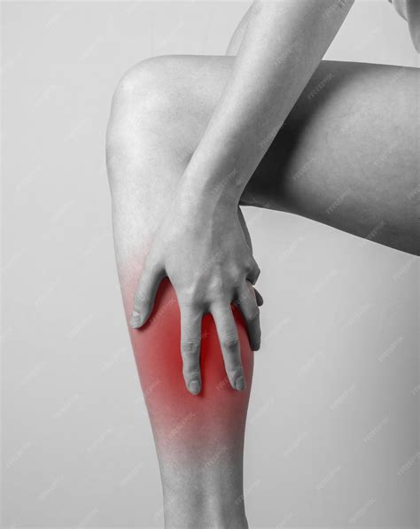 Premium Photo | Shin pain woman holding leg with red spot tendons