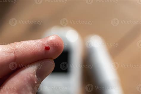 Woman pricking her finger to check blood glucose level with glucometer