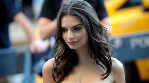 Download Emily Ratajkowski Exhibiting Elegant Poise In A Black Dress