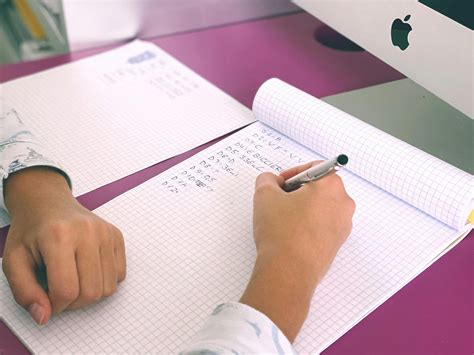 person writing  white squared paper  stock photo