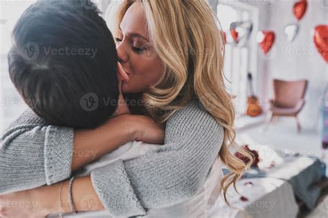 Love is in the air. Beautiful young woman kissing her boyfriend while