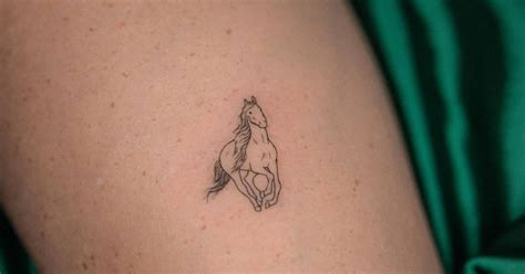 Fine line style horse tattoo located on the calf.