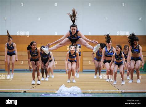 Young teenager cheerleaders dancing, acrobacy, acrobatic moves ...