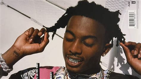 playboi carti is closing eyes and touching hair with fingers in white ...