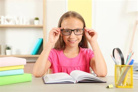 Little Girl with Glasses Reading a Book at Home Stock Photo - Image of ...