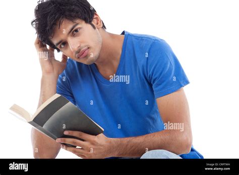 Portrait of young man holding book over white background Stock Photo ...