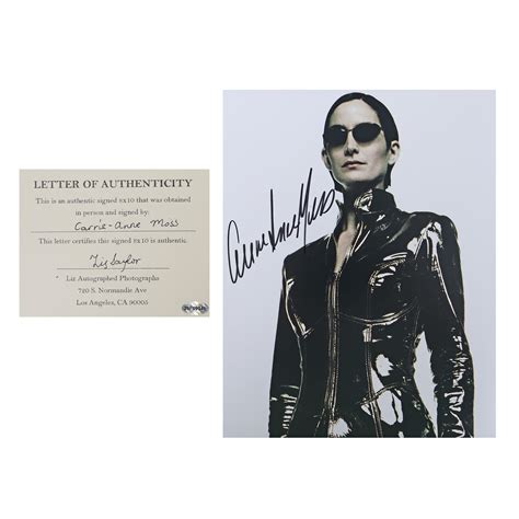 At Auction: Photograph illustrating Carrie Ann Moss, as Trinity from