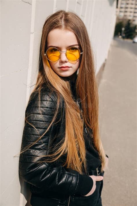 beautiful fashionable kid girl  long hair  yellow sunglasses