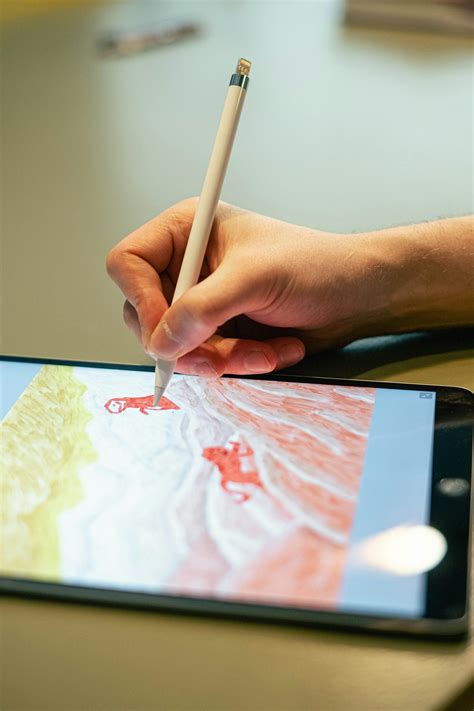 Person Sketching on a Tablet · Free Stock Photo