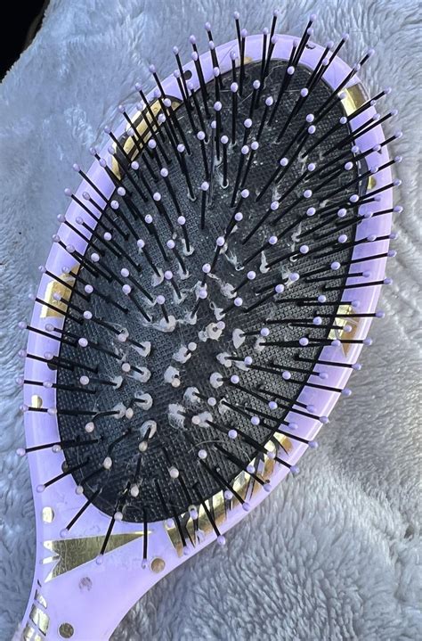 How do I remove/clean dust balls off my hair brush bristles more