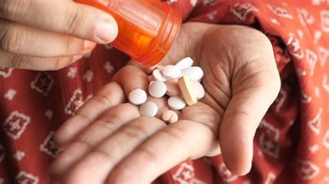 Close up of woman hand taking medicine 23210338 Stock Video at Vecteezy