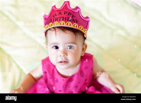 First birthday. Little cheerful baby girl with crown celebrating her ...