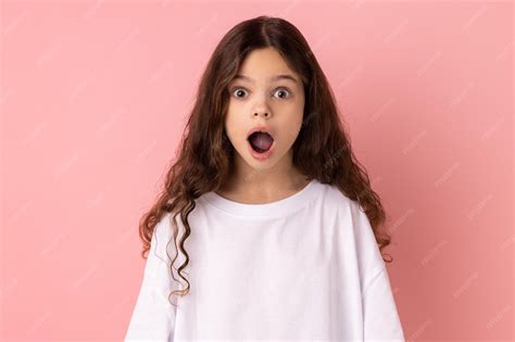 Premium Photo | Surprised little girl looking at camera with open mouth