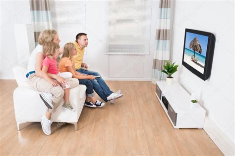 Young Family Watching TV Together — Stock Photo © AndreyPopov #55360421