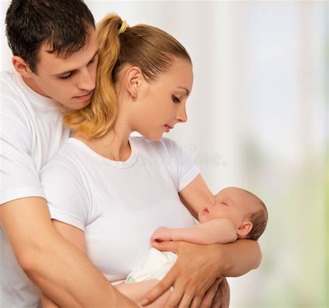 happy young family  mother father  newborn baby    stock