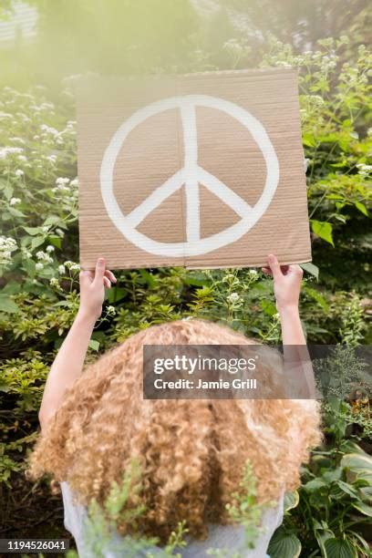 Holding Up Peace Sign Photos and Premium High Res Pictures - Getty Images