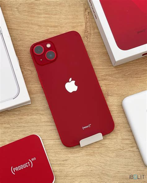 Apple iPhone13 Red Case and Accessories on Wooden Table