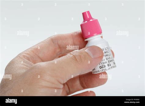 Pink cap eye drop bottle, antibiotic prescription medicine Stock Photo - Alamy