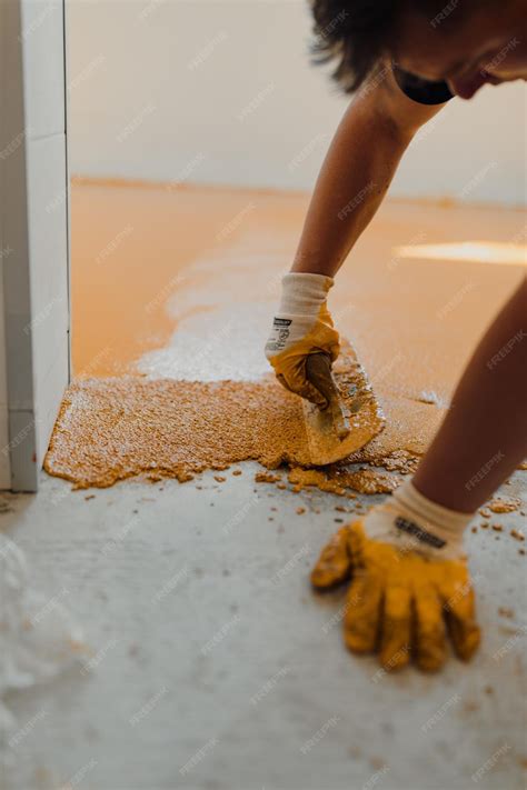 Premium Photo | Professional construction worker applying floor paint
