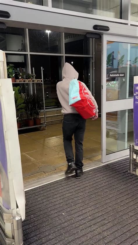 'Smug' shoplifter goads customers as he strolls out of store with bag