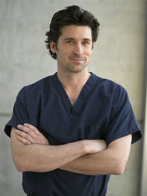 a man in scrubs is standing with his arms crossed