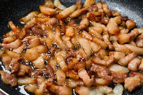 premium photo frying cracklings  cookware closeup pork lard
