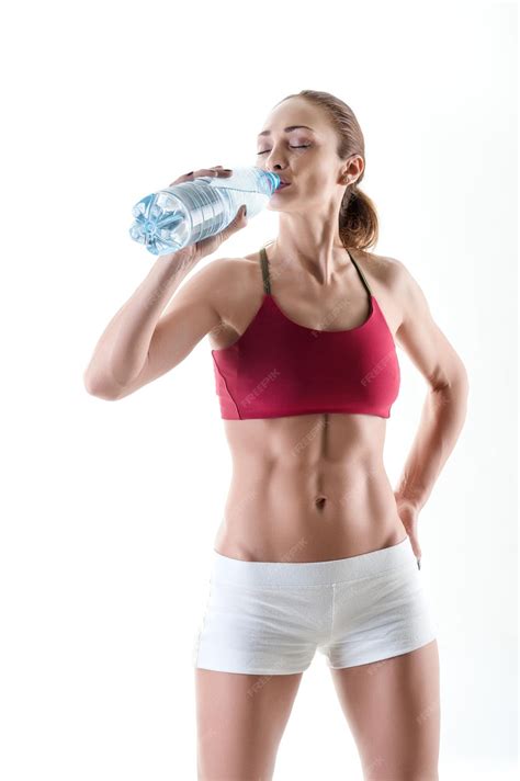 Premium Photo | Young woman hydrating after exercise