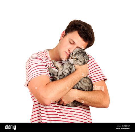 a guy holding a British cat in his arms and hugging her. emotional man ...