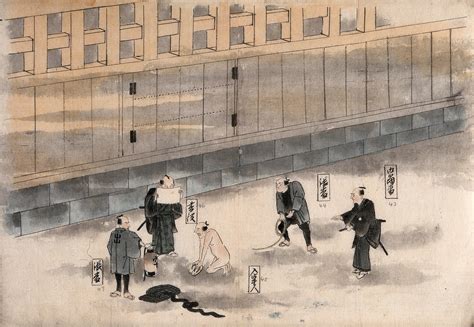 A Japanese prisoner is stripped naked and forced to kneel before